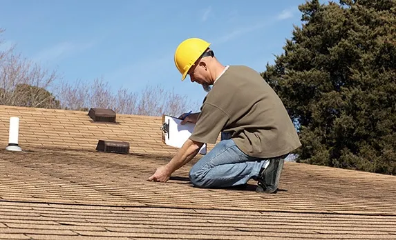 Roof repair work on a residential roof edge
